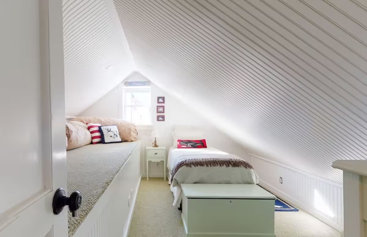 A daybed in the same attic room beneath the slope of the roof.