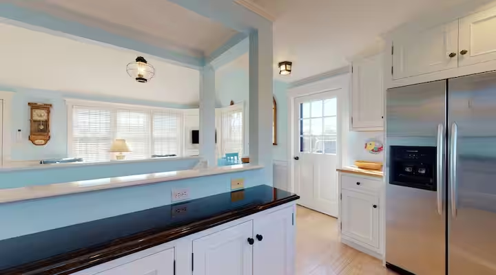 The kitchen seen through its opening to the adjoining room.